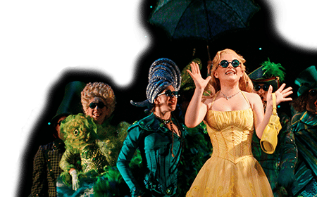 Glinda in the Emerald City With the Ensemble Behind Her