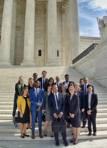 A Group Standing the Steps Outside a Building