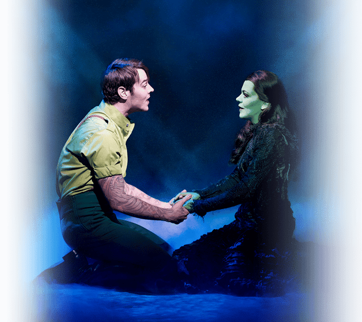 Fiyero and Elphaba Facing Each Other Holding Hands and Singing